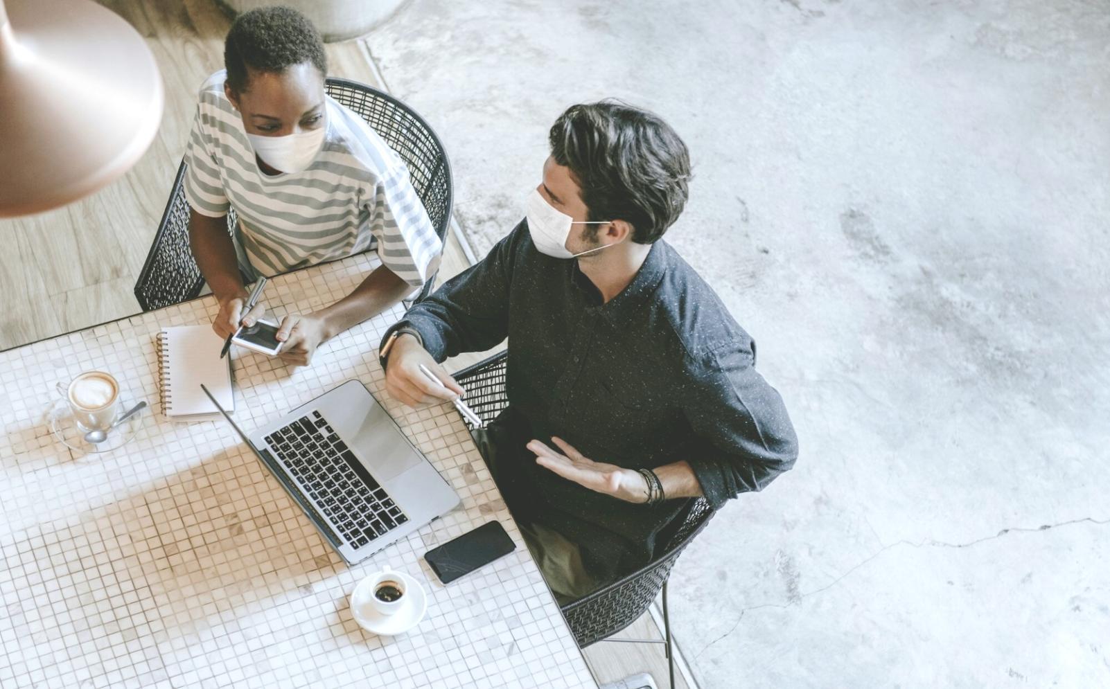 Modern classroom setup with financial charts on screens and collaborative workspace
